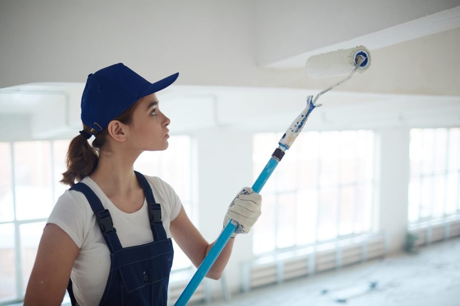 House painter renovating ceiling with whitewash
