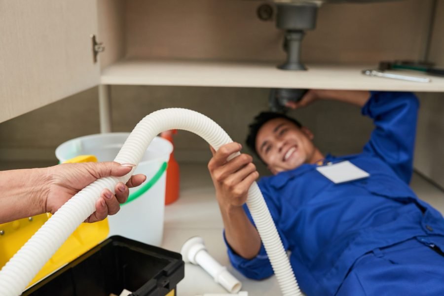 woman-giving-plastic-pipe-to-plumber.jpg
